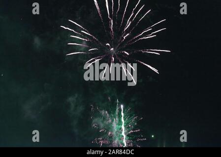 Bright green fireworks against the dark sky. Stock Photo