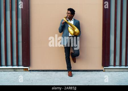 Funny handsome man with a golden color inflatable tube Stock Photo