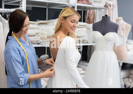 Dress fitting in tailoring studio Stock Photo