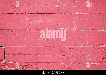 Brick wall scuffed painted pink texture background Stock Photo