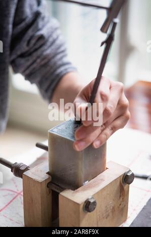 WUHAN, HUBEI/  CHINA - DEC 24 2019: The unspecific girl engraving of the stone for logo stamp in Wuhan, This  is one of the ancient culture of China. Stock Photo