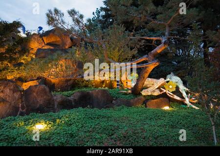 The Stone Mountain with illuminated snake and bird lanterns during the annual Magic of Lanterns exhibit in Chinese Garden at dusk in autumn Stock Photo