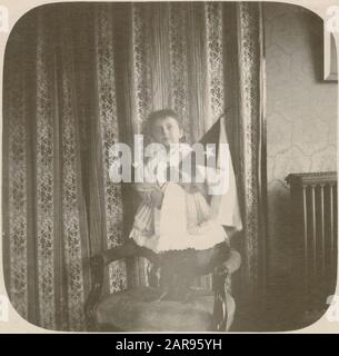 Antique 1898 photograph, young boy in a Victorian dress holding a Cuban flag. Location: New York, USA. SOURCE: ORIGINAL PHOTOGRAPH Stock Photo