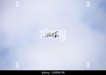 Small cessna 172 airplane soars through blue sky over the southwestern part of Florida. Stock Photo