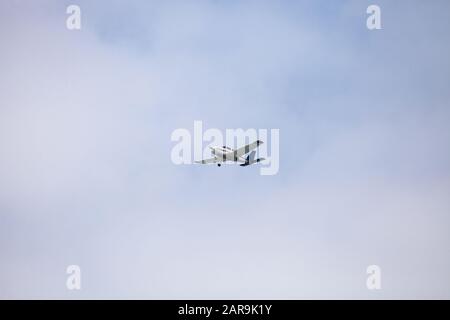 Small cessna 172 airplane soars through blue sky over the southwestern part of Florida. Stock Photo