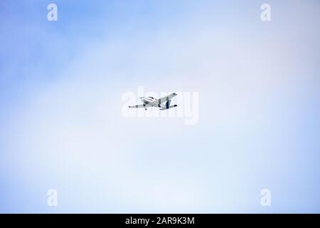 Small cessna 172 airplane soars through blue sky over the southwestern part of Florida. Stock Photo