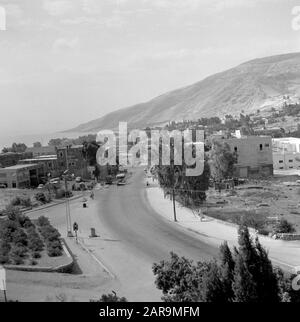 View of a part of the city of Tiberias with the surrounding hills and with a traffic road in the foreground. Israel, Lake Tiberias, Tiberias.; Stock Photo