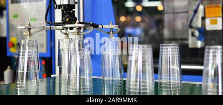 Clear Plastic glass transfer on Automated conveyor systems industrial automation for package Stock Photo