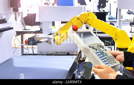 Engineer check and control automation yellow Modern Robot system in factory, Industry Robot concept . Stock Photo