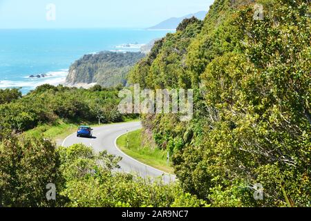 New Zealand Haast Highway: A scenic road winds along the western shore of New Zealand's South Island. Stock Photo