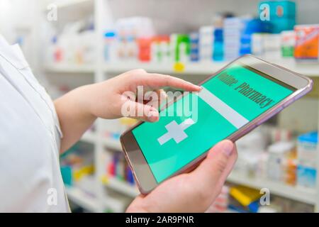 Doctor using computer tablet for search bar on display in pharmacy drugstore shelves background.Online medical concept. Stock Photo
