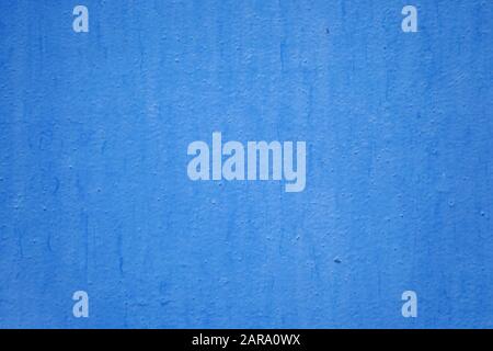 The wall is painted with blue oil paint. Blue wall texture for background and design Stock Photo