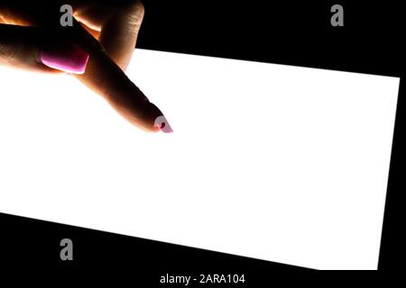 Tablet computer mockup in woman hand isolated on black background. Tablet laptop mockup with blank white screen at night. Empty space for text. Copy s Stock Photo