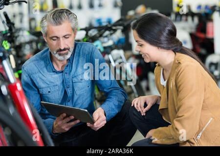 couple looking for bicycle in bike shop Stock Photo