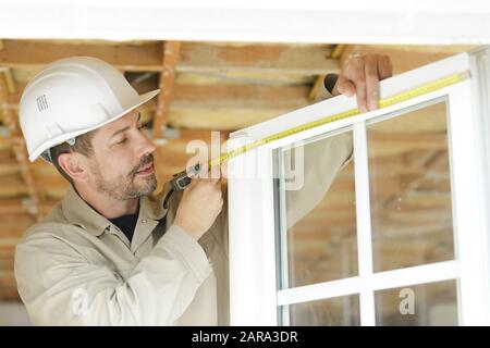 handyman measuring window for cassette roller blinds Stock Photo