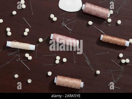 Group of sewing objects lying flat on a black chalkboard background. Horizontal background for ad or packaging. Stock Photo