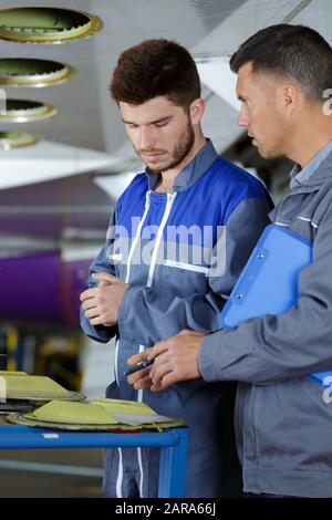 workers installing sound system in car Stock Photo