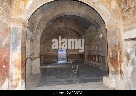 Part of the living room with frescoes painted on the walls in a ruined house in Pompeii, Naples, Italy. Stock Photo