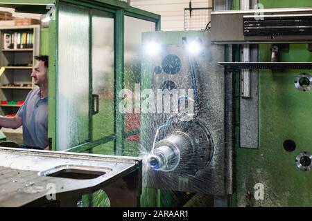 Worker operating industrial milling machine Stock Photo