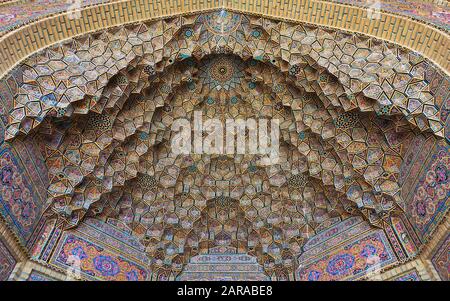 Colorful mosaic patterns and architectural details on the ceiling of Nasir Al-Mulk Mosque (Pink Mosque) in Shiraz, Stock Photo