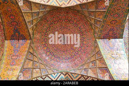 Colorful mosaic patterns and architectural details on the ceiling of Nasir Al-Mulk Mosque (Pink Mosque) in Shiraz, Stock Photo