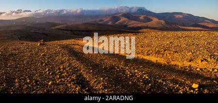 mountain road in the middle of the island of Fuerteventura at sunrise Stock Photo