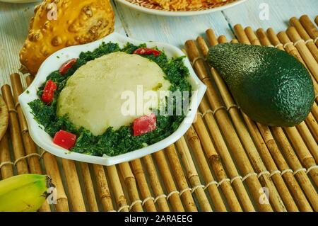 Ugali Sukuma Wiki, made with collard greens, known as sukuma, cooked with onions and spices. Kenyan cuisine, Traditional assorted African dishes, Top Stock Photo