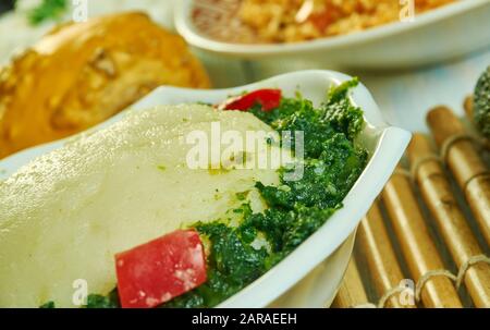 Ugali Sukuma Wiki, made with collard greens, known as sukuma, cooked with onions and spices. Kenyan cuisine, Traditional assorted African dishes, Top Stock Photo