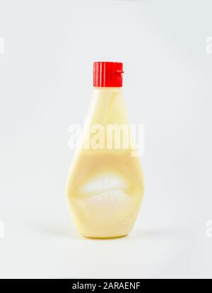 Used mayonnaise bottle on white backgrond, plastic bottle used Stock Photo