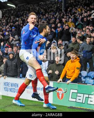 Ronan Curtis of Portsmouth leaps on the back of goalscorer Ben Close after their first goal during the Emirates FA Cup fourth round match between Portsmouth and Barnsley at Fratton Park ,  Portsmouth, UK - 25th January 2020 - Editorial use only. No merchandising. For Football images FA and Premier League restrictions apply inc. no internet/mobile usage without FAPL license - for details contact Football Dataco  : Stock Photo