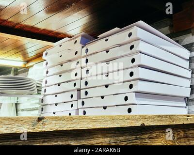 Courmayeur, Italy - January 18, 2020 Pile of empty white cardboard boxes of pizzas Stock Photo