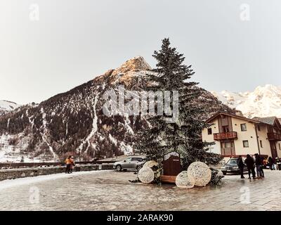 Courmayeur, Italy - January 18, 2020 View of the Christmas tree from the village of Courmayear in the Aosta Valley Italy with snowy mountains in the b Stock Photo