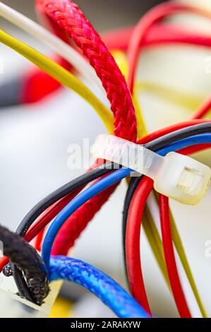 Multicolored electrical cables isolated close up. Vertical image. Selective focus. Stock Photo