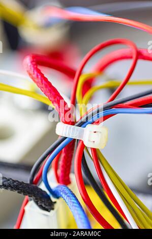 Multicolored electrical cables isolated close up. Vertical image. Selective focus. Stock Photo