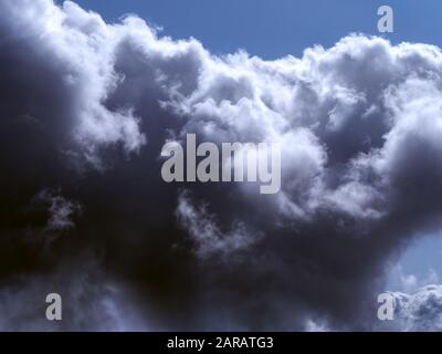Dark clouds against a bright blue sky Stock Photo