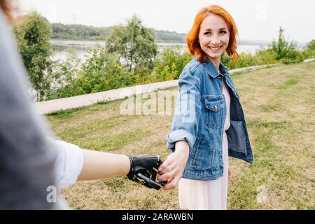 Happy woman gently holding her bionic husband by the hand Stock Photo