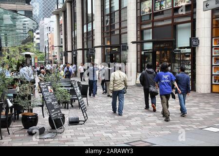 TOKYO, JAPAN - MAY 9, 2012: City life in Akasaka Sacas district of Minato, Tokyo, Japan. The Greater Tokyo Area is the most populous metropolitan area Stock Photo