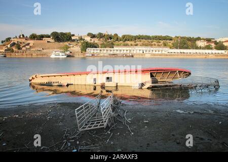 BELGRADE, SERBIA - AUGUST 15, 2012: Sunk restaurant boat in Belgrade. Sava River embankment in Belgrade is lined with multiple restaurant ships. Stock Photo