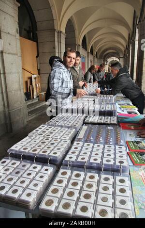 MADRID, SPAIN - OCTOBER 21, 2012: Shoppers visit Sunday Collectible Market in Plaza Mayor, Madrid. The weekly market is one of most popular of its kin Stock Photo