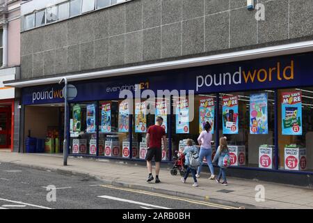 BARNSLEY, UK - JULY 10, 2016: People walk by Poundworld discount store in Barnsley, UK. Poundworld has over 350 stores in the UK. Stock Photo