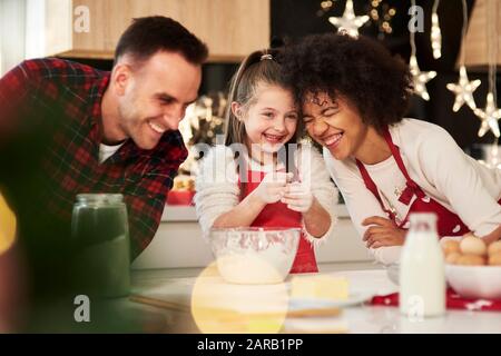 Family preparing snack in kitchen Stock Photo