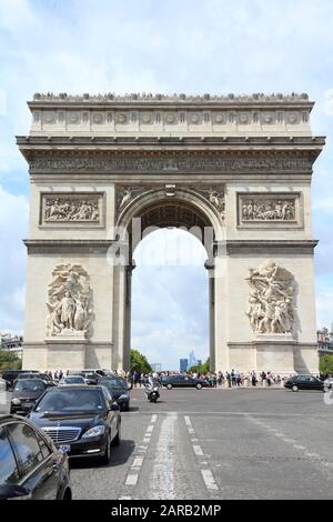 PARIS, FRANCE - JULY 25, 2011: People drive in Paris, France. Place Charles de Gaulle is a unique road junction with 12 avenues meeting next to Triump Stock Photo