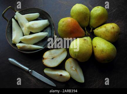 Organic pears 'Conference' on dark wood Stock Photo