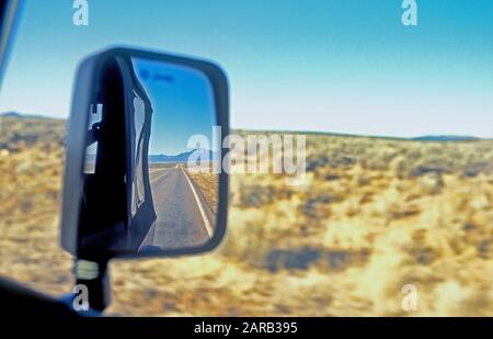 Rear view in mirror driving through New Mexico USA 1999 Stock Photo