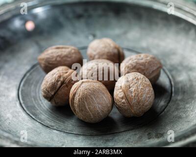 walnut on a metal plate Stock Photo