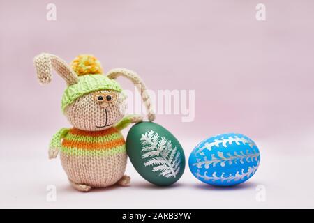 knitted rabbit and two Easter eggs for a postcard Stock Photo
