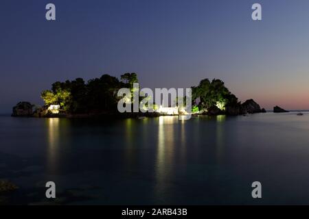 Viewed here is Panagia Island with the Church of The Virgin Mary, just a short swim or boat journey from very nearby Parga Town. Stock Photo