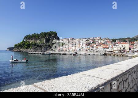 Viewed here and set in the Ionian Sea lies the beautiful Greek Town of Parga.Local fishermen visible in their small boat. Stock Photo