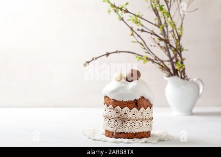 Easter composition with Easter cake (kulich), willow branches on a light background Stock Photo