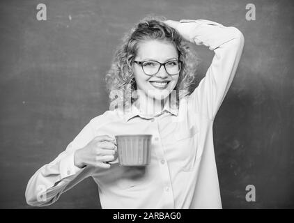 Great time. energy and vigor. energy charge. school teacher need coffee break. good morning. girl refreshing with tea drink. idea and inspiration. woman with coffee cup at blackboard. Stock Photo